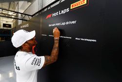 Lewis Hamilton, Mercedes AMG F1, signs the Pirelli hot lap board