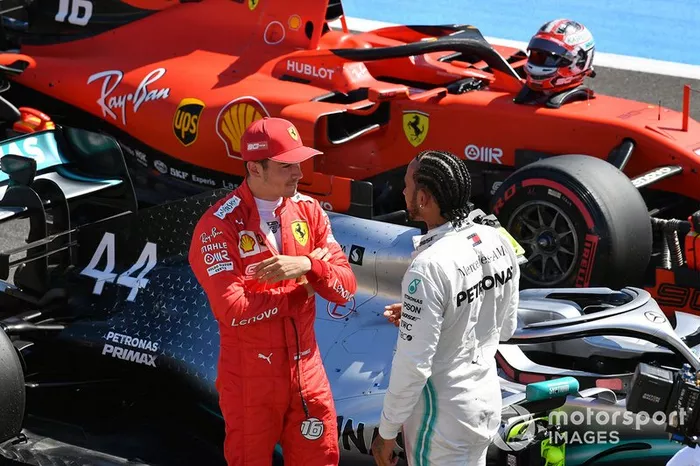 Charles Leclerc, Ferrari, talks with pole man Lewis Hamilton, Mercedes AMG F1, on the grid after Qualifying