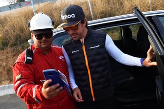 Fernando Alonso watches the action trackside