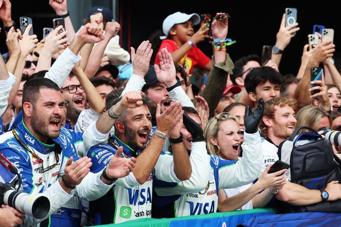 Team members of Visa Cash App Racing Bulls celebrate in parc ferme