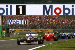 Jacques Villeneuve, Williams FW19 Renault leads Michael Schumacher, Ferrari F310B and Olivier Panis,