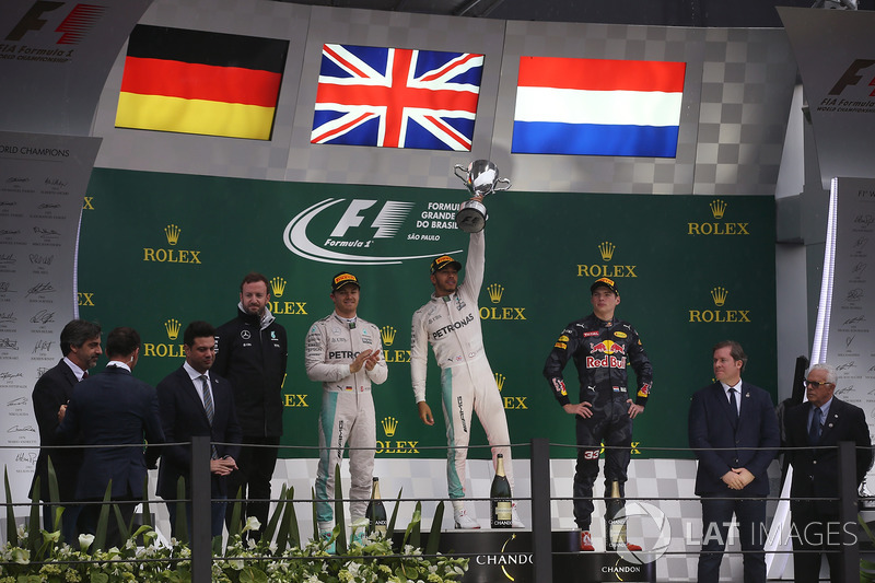 Lewis Hamilton, Mercedes AMG, celebrates victory on the podium alongside Nico Rosberg, Mercedes F1 W