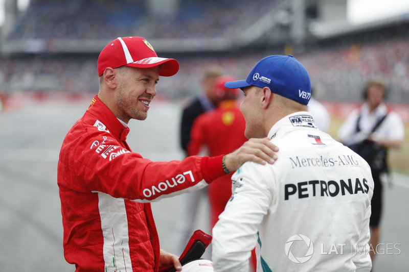 Sebastian Vettel, Ferrari, celebrates his pole position, with Valtteri Bottas, Mercedes AMG F1