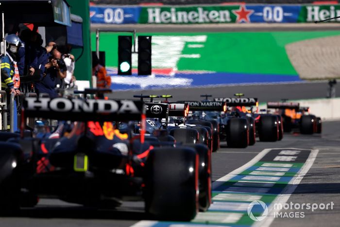 Lewis Hamilton, Mercedes W12, and Max Verstappen, Red Bull Racing RB16B, in the pit lane