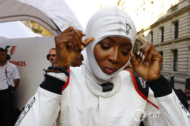 Naomi Campbell prepares for a ride in a 2 seat car, Jenson Button, McLaren