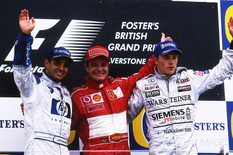 The podium: Juan Pablo Montoya, Williams, second; Rubens Barrichello, Ferrari, winner; Kimi Raikkonen, McLaren, third