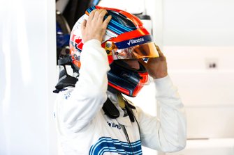 Robert Kubica, Williams Martini Racing, adjusts his crash helmet