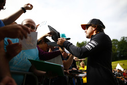 Fernando Alonso, McLaren, signs autographs for fans