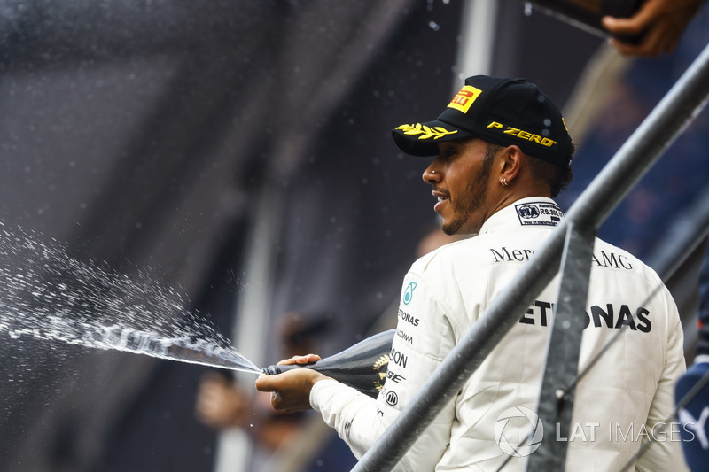 Race winner Lewis Hamilton, Mercedes AMG F1, sprays Champagne on the podium