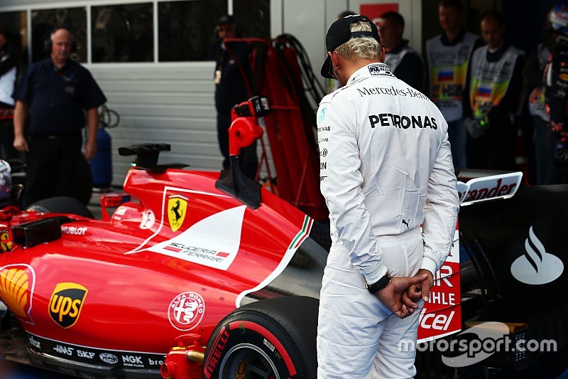 Lewis Hamilton, Mercedes AMG F1 looks at the Ferrari SF15-T of Sebastian Vettel, Ferrari in parc ferme