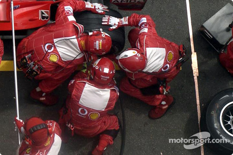 Ferrari team members at work during Rubens Barrichello's pitstop at