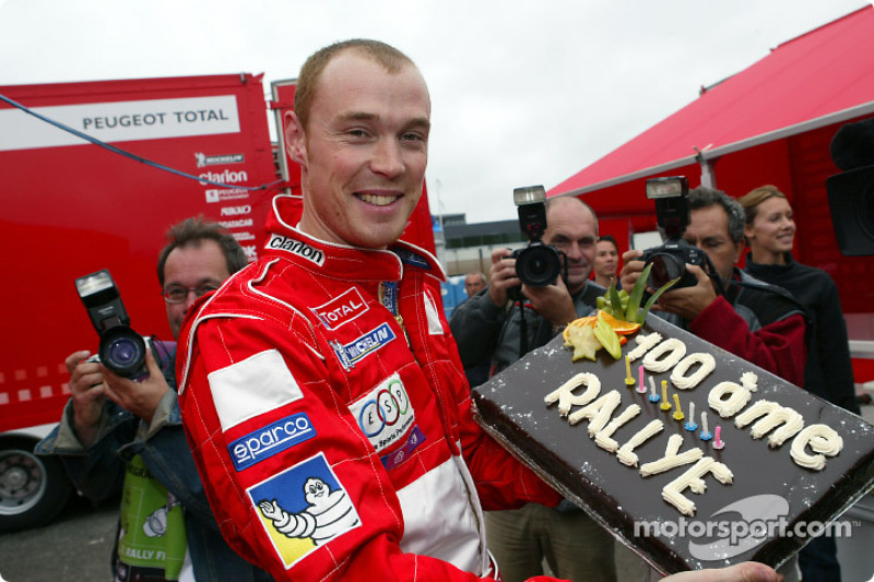 Richard Burns celebrates his 100th World Championship rally