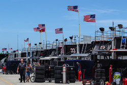 American flags wave over Daytona International Speedway garage area