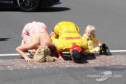 Ryan Hunter-Reay of Andretti Auto Sport along with his wife Beccy and son Ryden kiss the bricks at the Indianapolis Motor Speedway after winning the 98th Running of the Indianapolis 500 Mile Race.