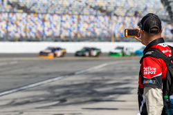A crew member takes video of practice
