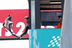 Keanu Reeves waves the flag to start the race