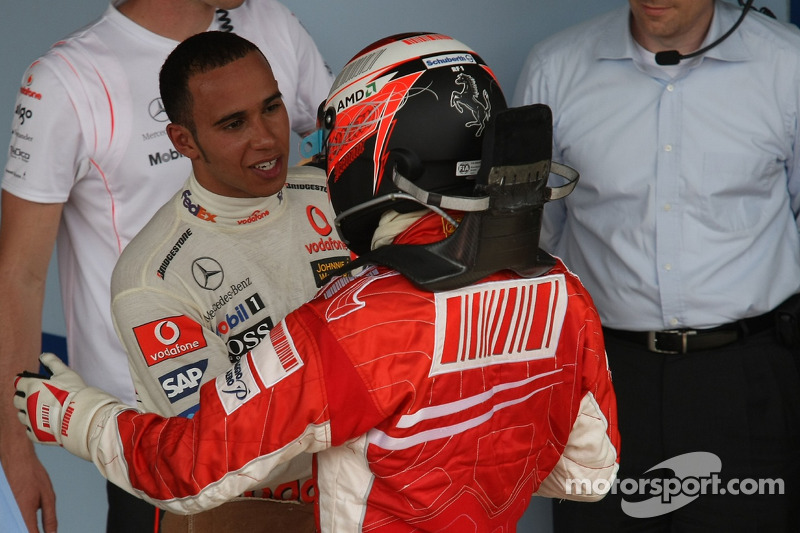 Race winner and 2007 World Champion Kimi Raikkonen congratulated by Lewis Hamilton