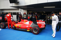 Lewis Hamilton, Mercedes AMG F1 W06 looks at the Ferrari SF15-T of Sebastian Vettel, Ferrari in parc ferme