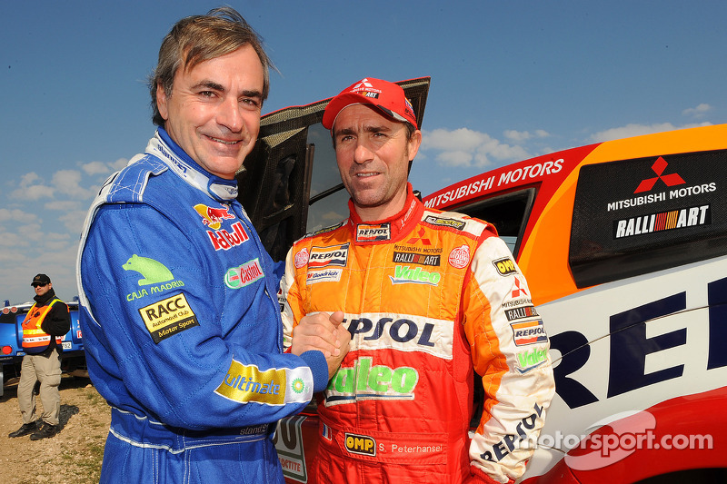 Rally winner Carlos Sainz celebrates with runner-up Stéphane Peterhansel