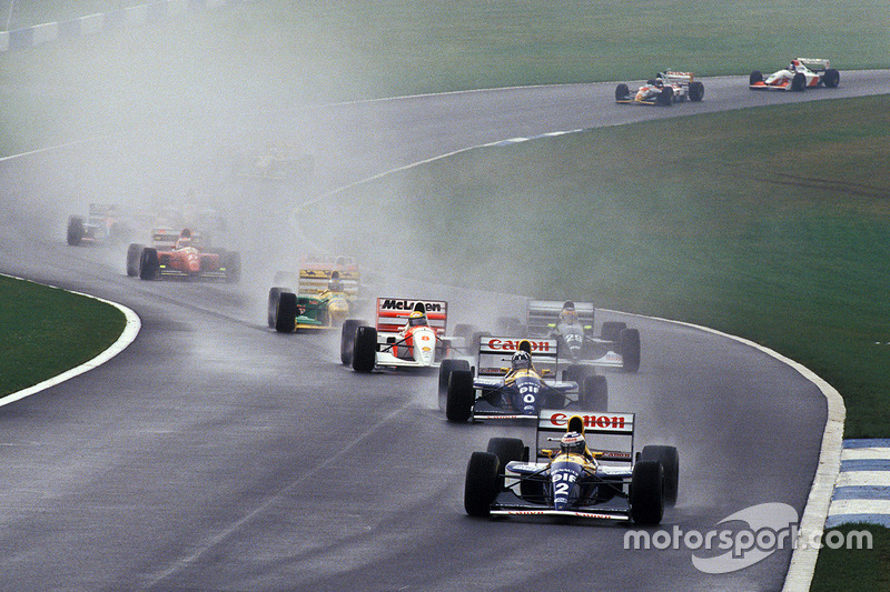 Ayrton Senna cuts through the field on the first lap, as Alain Prost leads